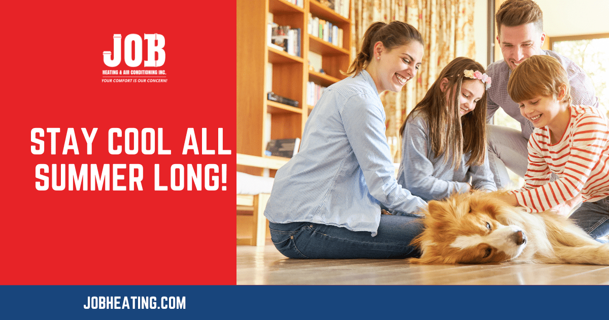 happy family playing with dog enjoying air conditioning inside home